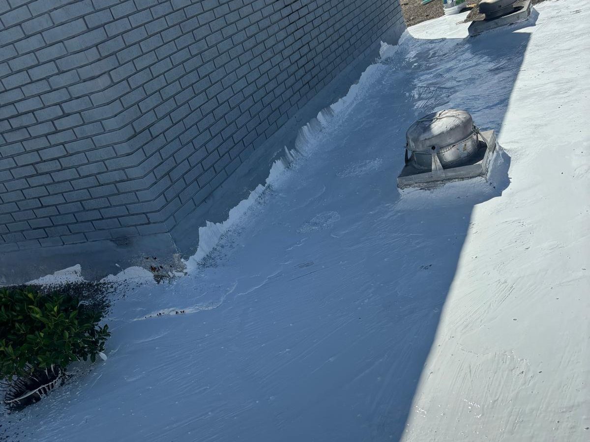 Silicone roof coating applied over an aged low-slope commercial roof