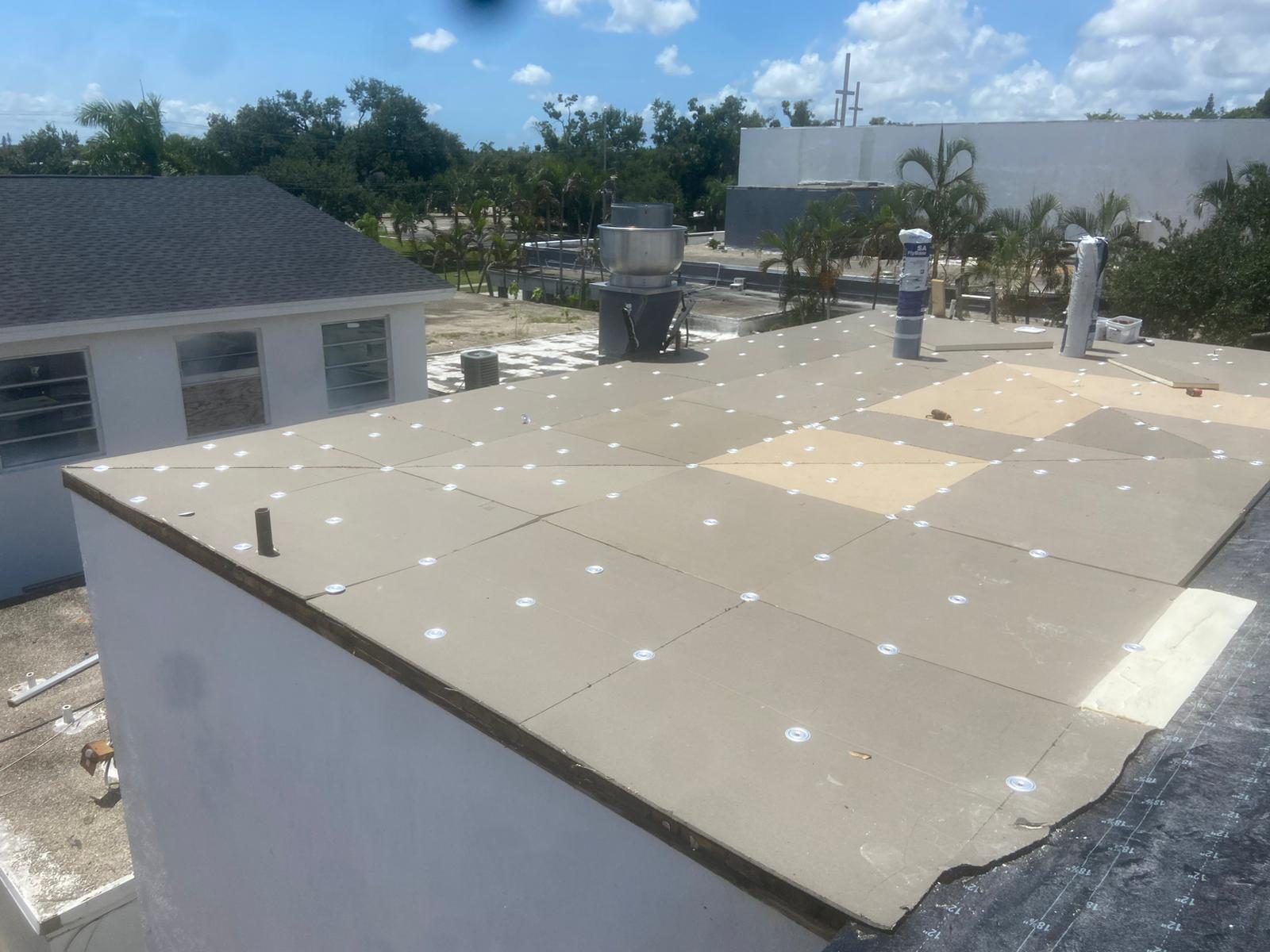 Technician inspecting a TPO membrane seam on a Baton Rouge commercial roof