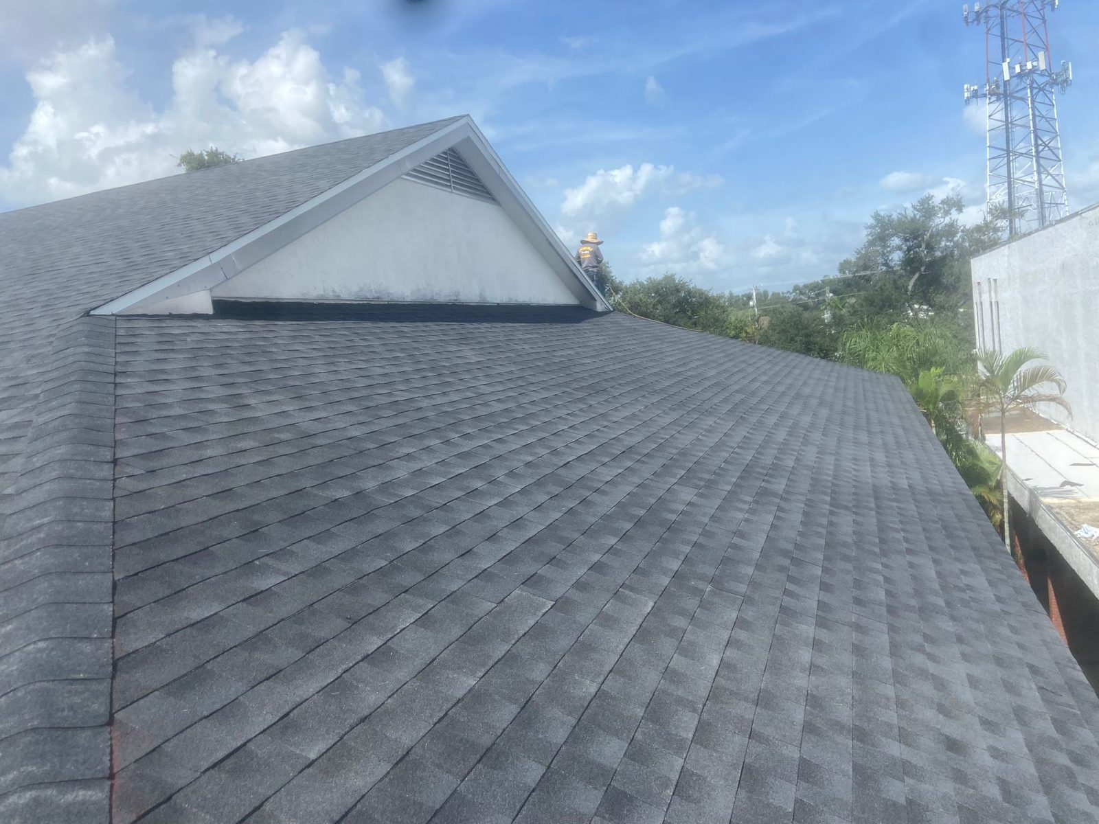Homeowners in front of their completed roof on a brick home near Baton Rouge, Louisiana